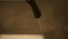 a close up of a person 's nipple and a stream of water