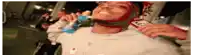a man is brushing his teeth with a toothbrush while holding a cell phone .