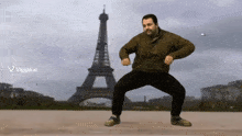 a man dancing in front of the eiffel tower with a viggle.ai logo