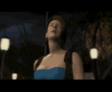 a woman in a blue dress is in a video game scene