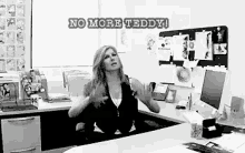 a woman sitting at a desk with the words no more teddy