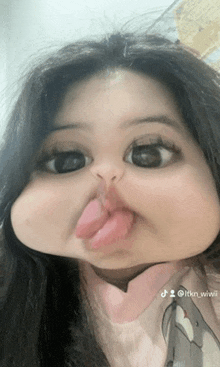 a baby making a funny face with her tongue sticking out