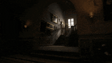 a dark hallway with a staircase and a window