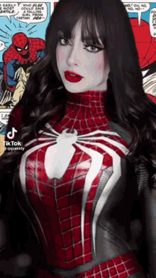 a woman in a spider-man costume is standing in front of a comic book page