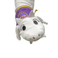 a stuffed animal with a purple blanket and a yellow triangle on it