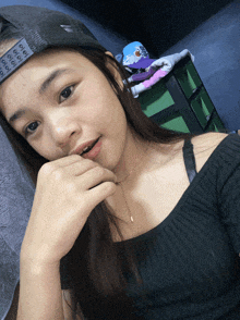 a girl wearing a black shirt and a hat that says ' oioioi ' on it