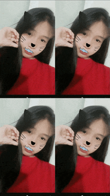 a girl in a red shirt has a cat ear on her face