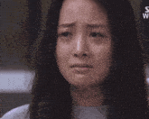 a close up of a woman 's face with a s on the bottom right