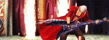 a man in a red cape is holding a blue guitar and a sword .