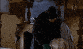a man in a top hat is standing next to a woman in a room