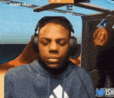 a man wearing headphones is sitting in front of a computer monitor .