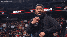 a man speaking into a microphone with the words " hell yeah i 'm crashing out " behind him