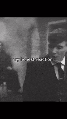 a black and white photo of a man in a suit and tie with the words my honest reaction