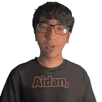 a young man wearing glasses and a black shirt with the name aidan on it