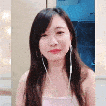 a woman wearing headphones and a pink tank top