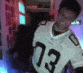a blurry picture of a man wearing a jersey with the number 73 on it