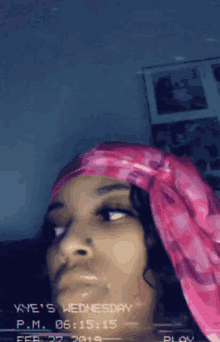 a woman wearing a pink head scarf on wednesday february 27th 2019