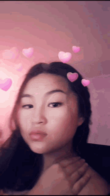 a girl with hearts in her hair is looking at the camera