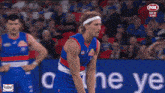 a fox live broadcast of a soccer game with a man wearing a headband