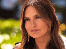 a close up of a woman 's face with a smile on her face