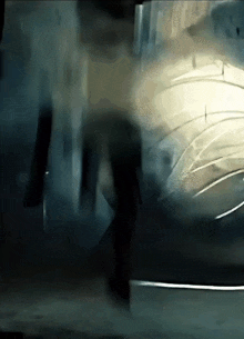 a blurred image of a person walking in a dark room .