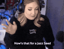 a woman wearing headphones and a black sweatshirt that says stay salty