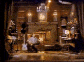 a man is sitting in a chair playing a guitar