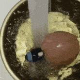a close up of a bowl of food with water coming out of it