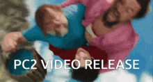 a blurred image of a man holding a child with the words " pc2 video release " below it