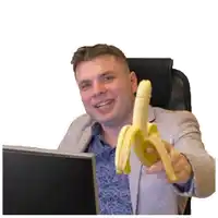 a man in a suit is holding a banana in front of his face