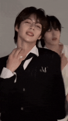 a man in a suit and tie is being held by another man .
