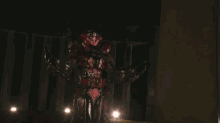 a person is surrounded by red lights and smoke in a dark room