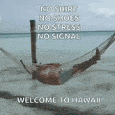 a person is laying in a hammock on the beach with a welcome to hawaii message .