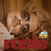 a woman laying down with a cigarette in her mouth and a taxi in the background with the word lose on it
