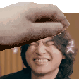 a close up of a person 's face with a hand holding it over it .