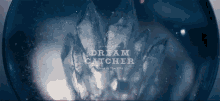 a dream catcher logo is displayed on a dark background