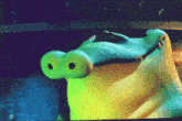 a close up of a cartoon crocodile 's face with a blue background