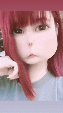 a woman with red hair and black eyes is making a face