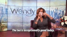 wendy drinking a cup of tea in front of a screen that says the tea is exceptionally good today