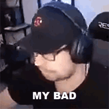 a man wearing a hat and headphones says " my bad "