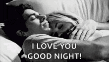 a man and a woman are laying in bed hugging each other and the man is saying `` i love you good night '' .