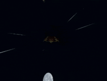 a person is standing under a palm tree at night looking up at the stars .