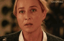 a close up of a woman 's face with the words offspring written on the bottom .