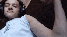 a young man wearing headphones and a white shirt that says inspire