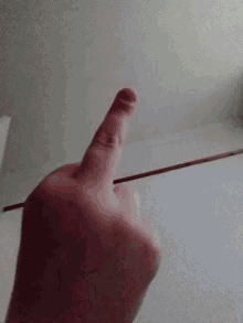 a person 's finger is pointing at something