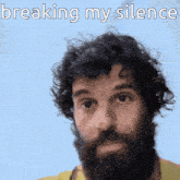 a man with curly hair and a beard has the words breaking my silence above him