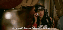 a woman is talking on a cell phone and saying i 'm probably fine