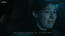 a woman in a dark room says " they control me "