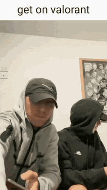 a man wearing a nike hat is sitting next to another man