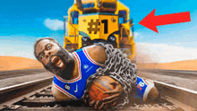 a basketball player is chained to a train track while holding a ball .